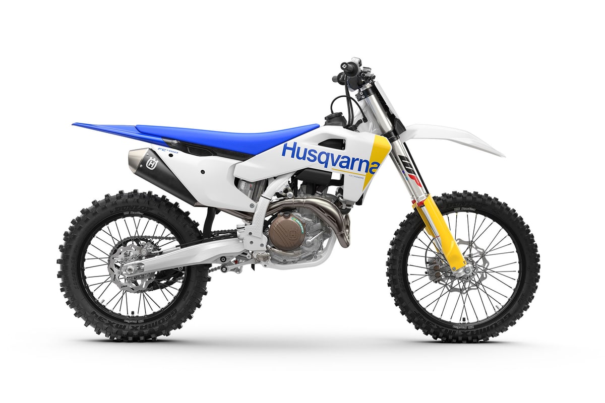 2027 Husqvarna FC 450 motocross bike in white and blue, right-side studio profile on white showing the yellow WP fork legs, spoked wheels and aluminium silencer