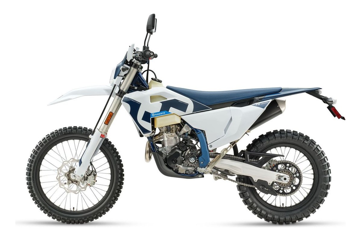2027 Husqvarna FE 350s enduro in white and blue, left-side studio profile showing the tucked exhaust, spoked wheels and tall fender