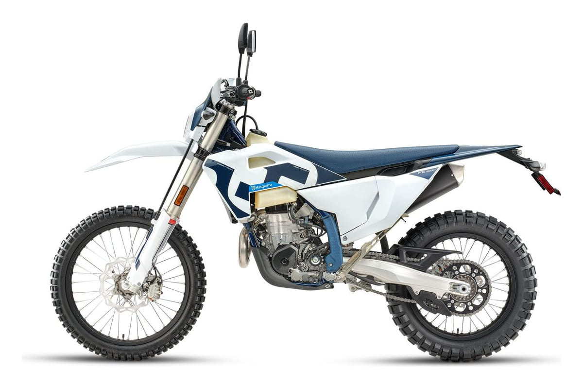 2027 Husqvarna FE 501s enduro motorcycle in blue, yellow and white, right-side studio profile showing spoked wheels and upswept exhaust