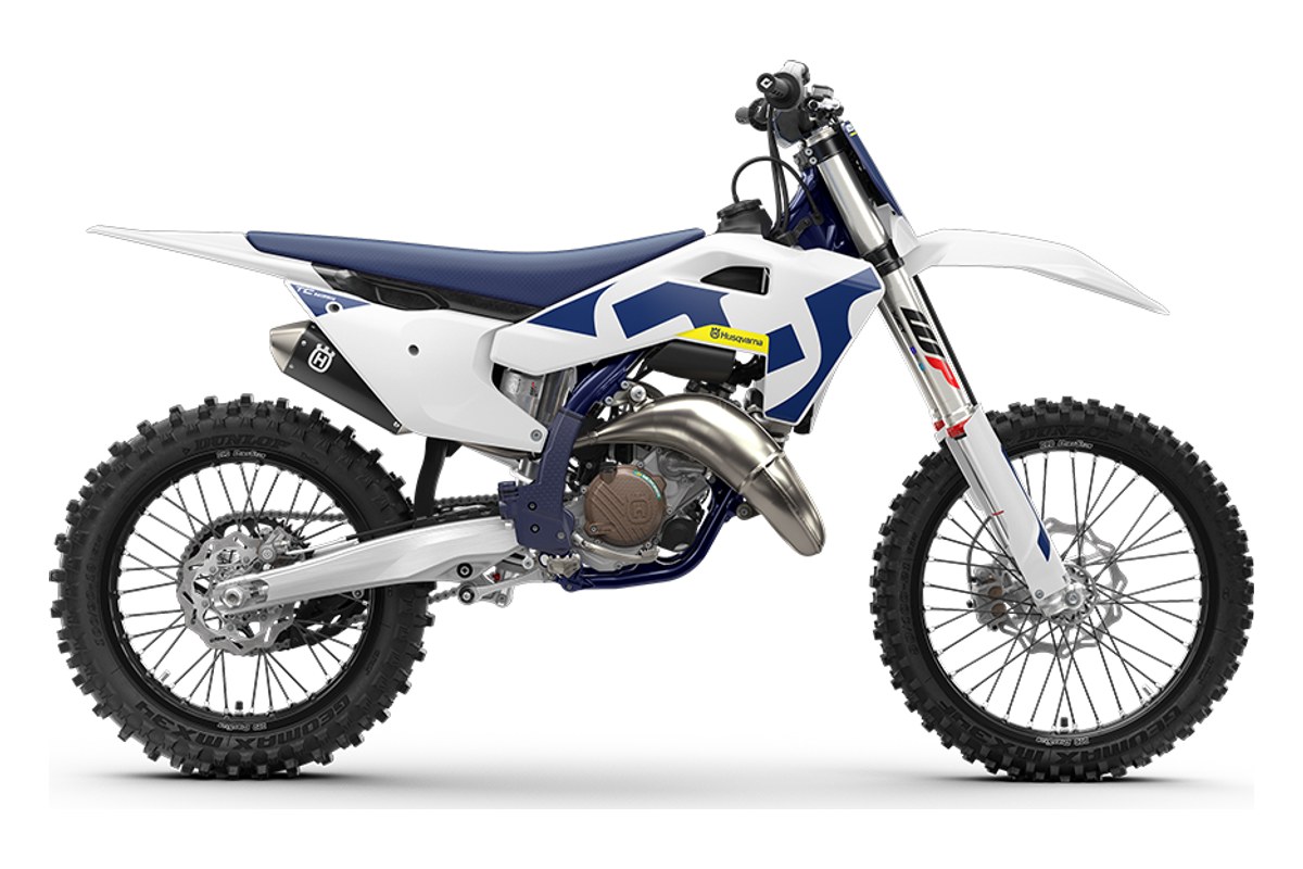 2027 Husqvarna TC 125 motocross bike in white and blue, right-side studio profile showing the inverted forks and stainless exhaust pipe