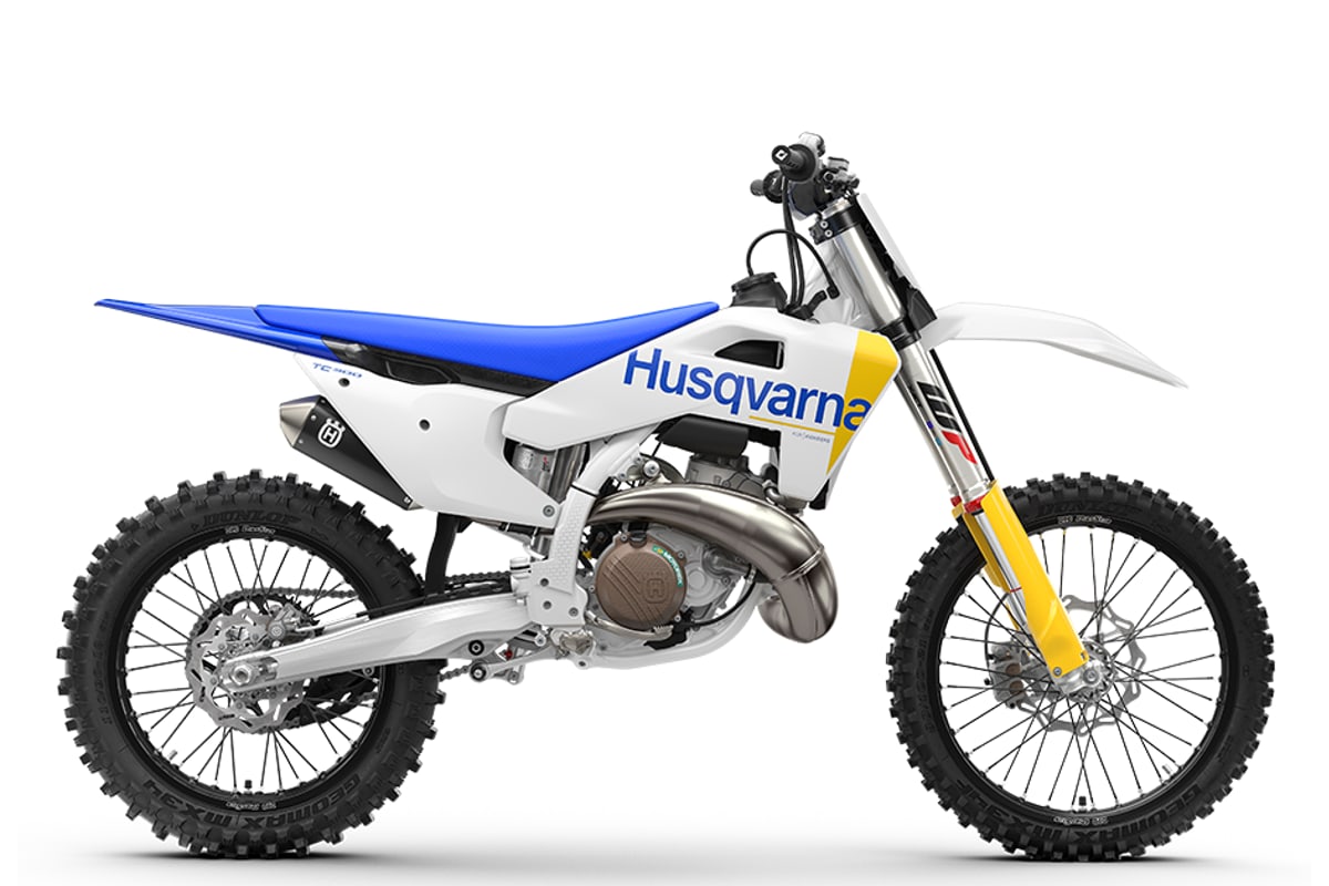 2027 Husqvarna TC 300 two-stroke motocross bike in white and blue, right-side studio profile showing the WP XACT fork and expansion chamber