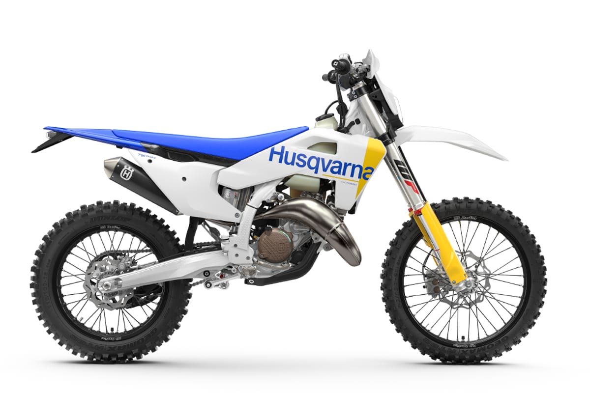 2027 Husqvarna TE 150 two-stroke enduro in white and blue, right-side studio profile showing the yellow WP forks and expansion chamber