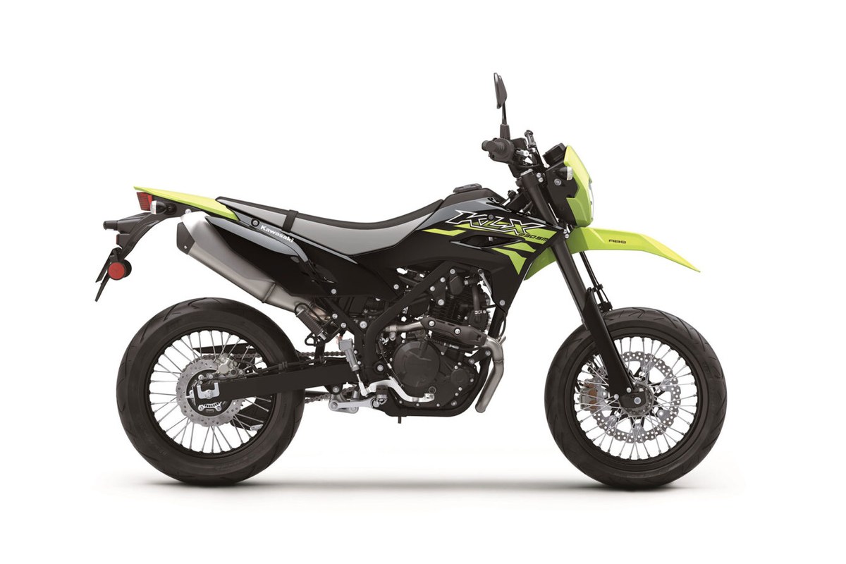 2027 Kawasaki KLX230SM ABS in lime green and black, right-side studio profile showing spoked supermoto wheels and stubby exhaust