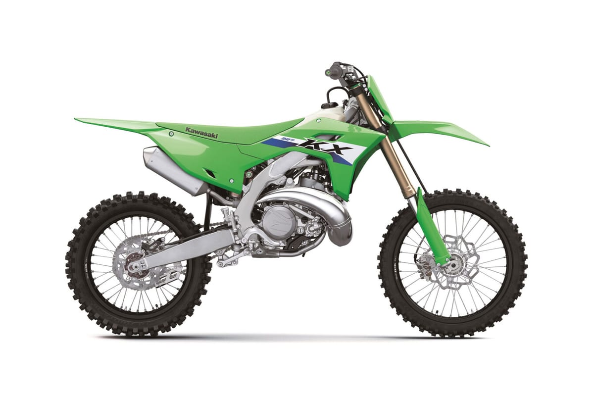2027 Kawasaki KX327 motocross bike in lime green, right-side studio profile showing the chrome exhaust pipe and gold-coated forks
