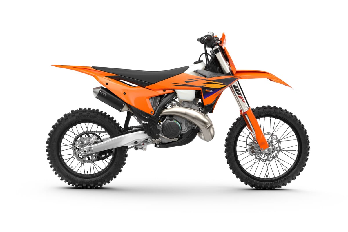 2027 KTM 250 XC cross-country two-stroke in orange with black seat, right-side studio profile showing the WP forks and stainless expansion chamber