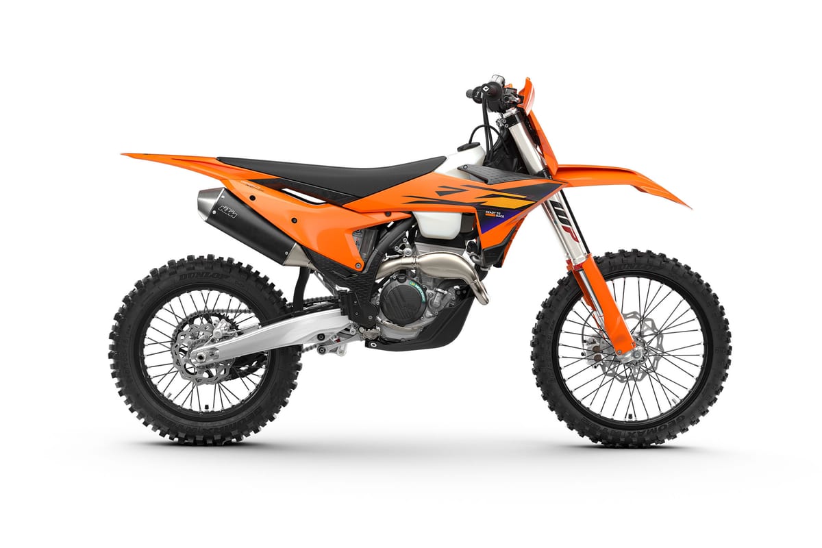 2027 KTM 250 XC-F cross-country bike in orange and black, right-side studio profile showing the WP fork, FMF-style silencer and Dunlop knobby tires