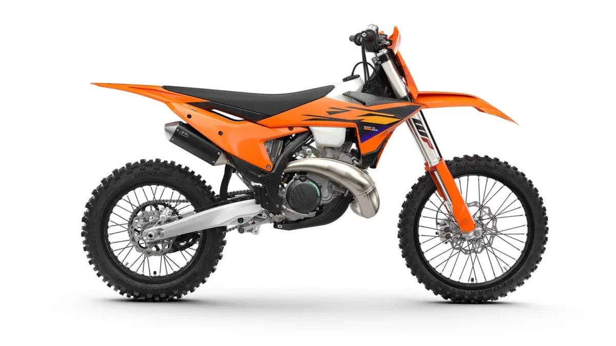 2027 KTM 300 XC two-stroke cross-country bike in orange with black and white bodywork, right-side studio profile