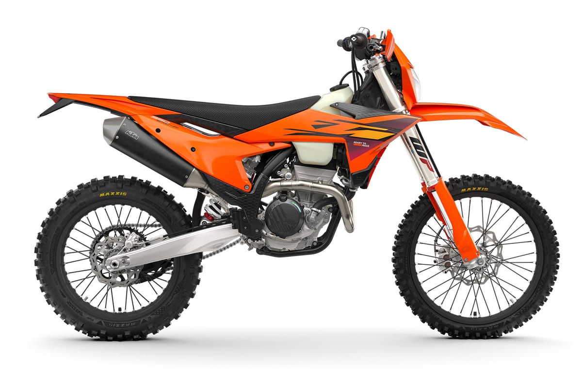 KTM 350 EXC-F left-side studio profile with orange bodywork and sharp graphic decals, showing the inverted WP fork and disc brakes