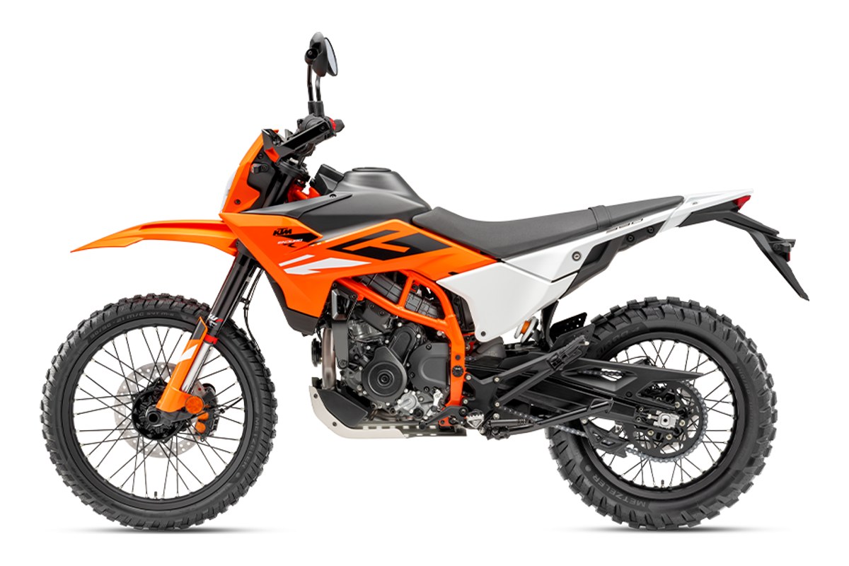 2026 KTM 390 Enduro R dual-sport in orange, white and black, right-side studio profile showing the WP inverted fork, spoked wheels and knobby tires