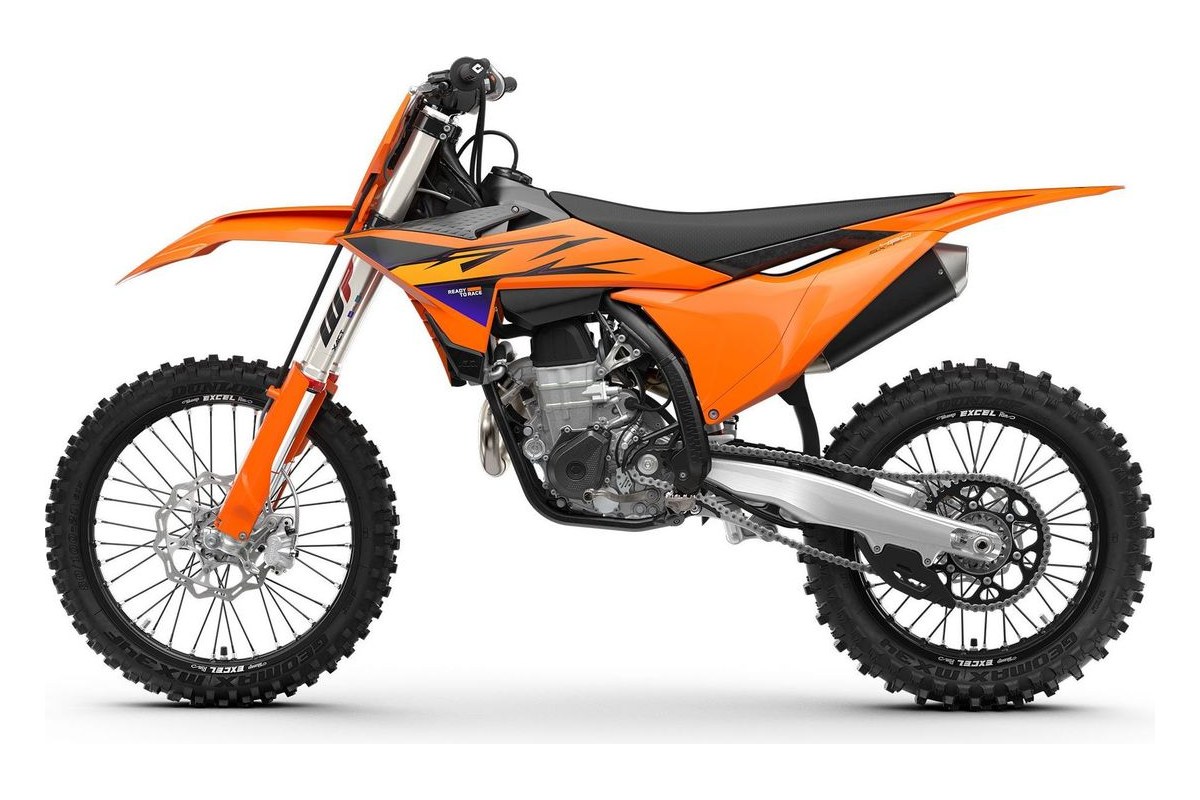 2027 KTM 450 SX-F motocross bike in orange with black bodywork, right-side studio profile showing WP forks, spoked wheels and slip-on muffler