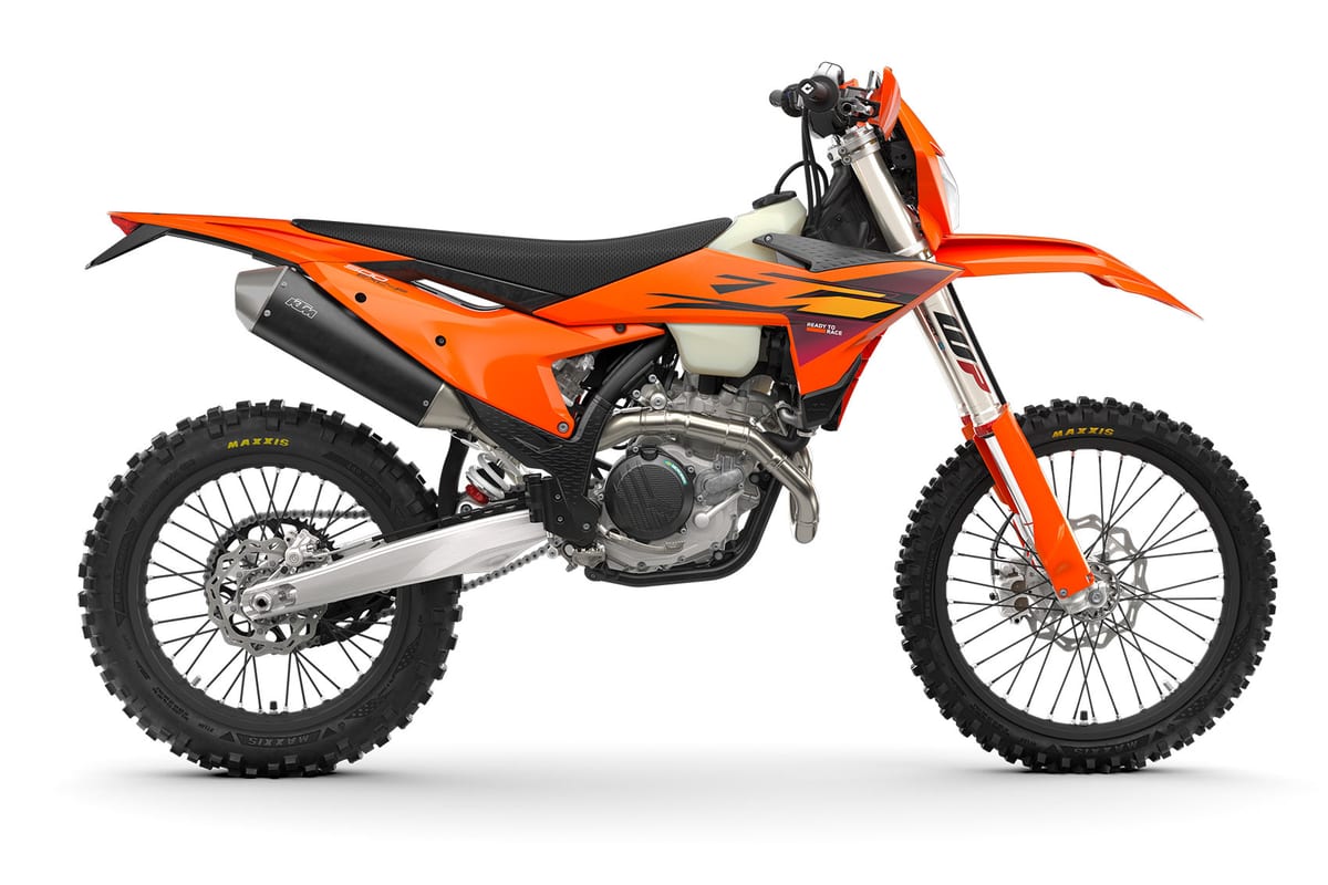 KTM 500 EXC-F left-side studio profile highlighting the muffler, black airbox cover and spoked wheels with Maxxis tires