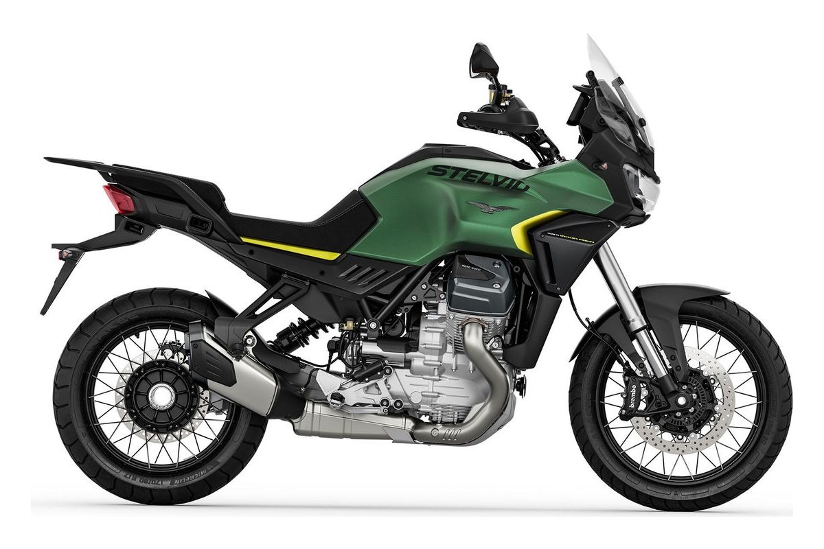 2027 Moto Guzzi Stelvio adventure motorcycle in green with yellow accents, right-side studio profile showing spoked wheels and transverse V-twin engine