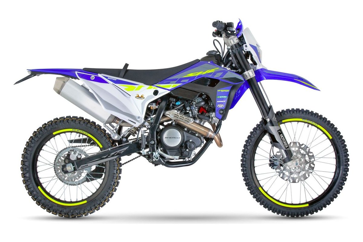 2026 Sherco 125 4T SE-RS Factory dual-sport in blue and white with neon yellow rim tape, left-side studio profile showing inverted forks and stub exhaust