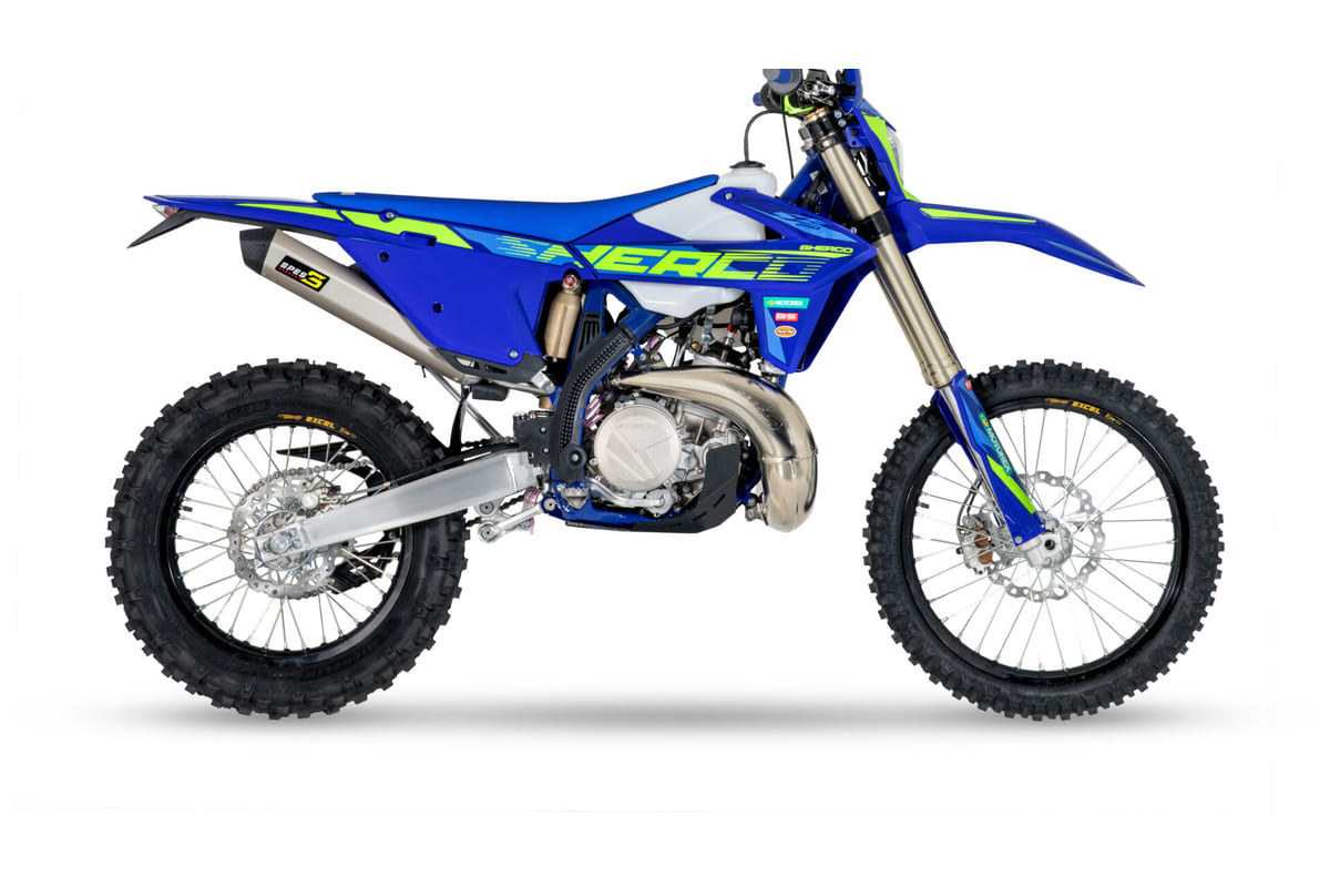 2027 Sherco 250 SE Factory enduro bike in blue with neon green graphics, right-side studio profile showing the SPES titanium exhaust and Excel rims