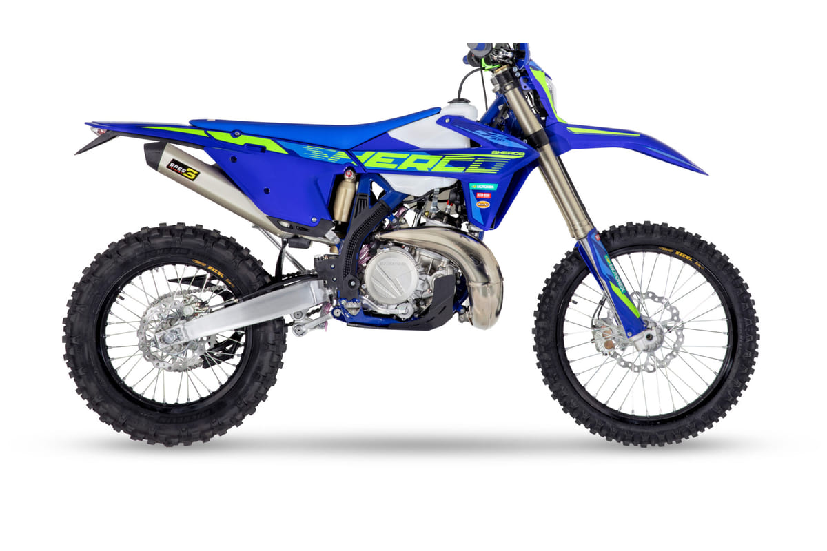 2027 Sherco 300 SE Factory two-stroke enduro in blue and white, right-side studio profile showing the titanium exhaust and Excel rims