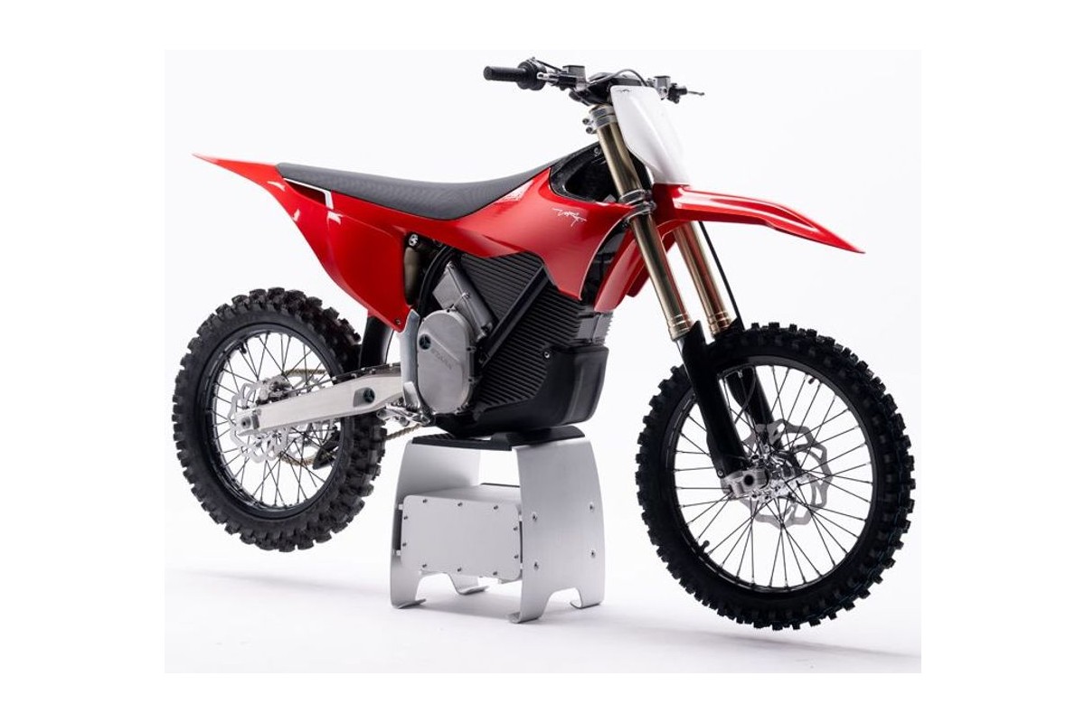 Stark Varg MX 1.2 electric motocross bike in red, side view on Stark's black studio backdrop