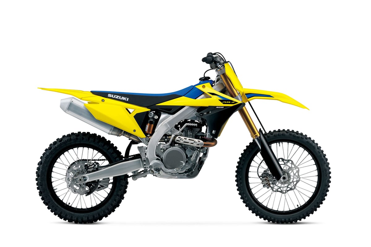 2027 Suzuki RM-Z450 motocross bike in yellow and blue, left-side studio profile showing gold forks, upswept exhaust and spoked wheels