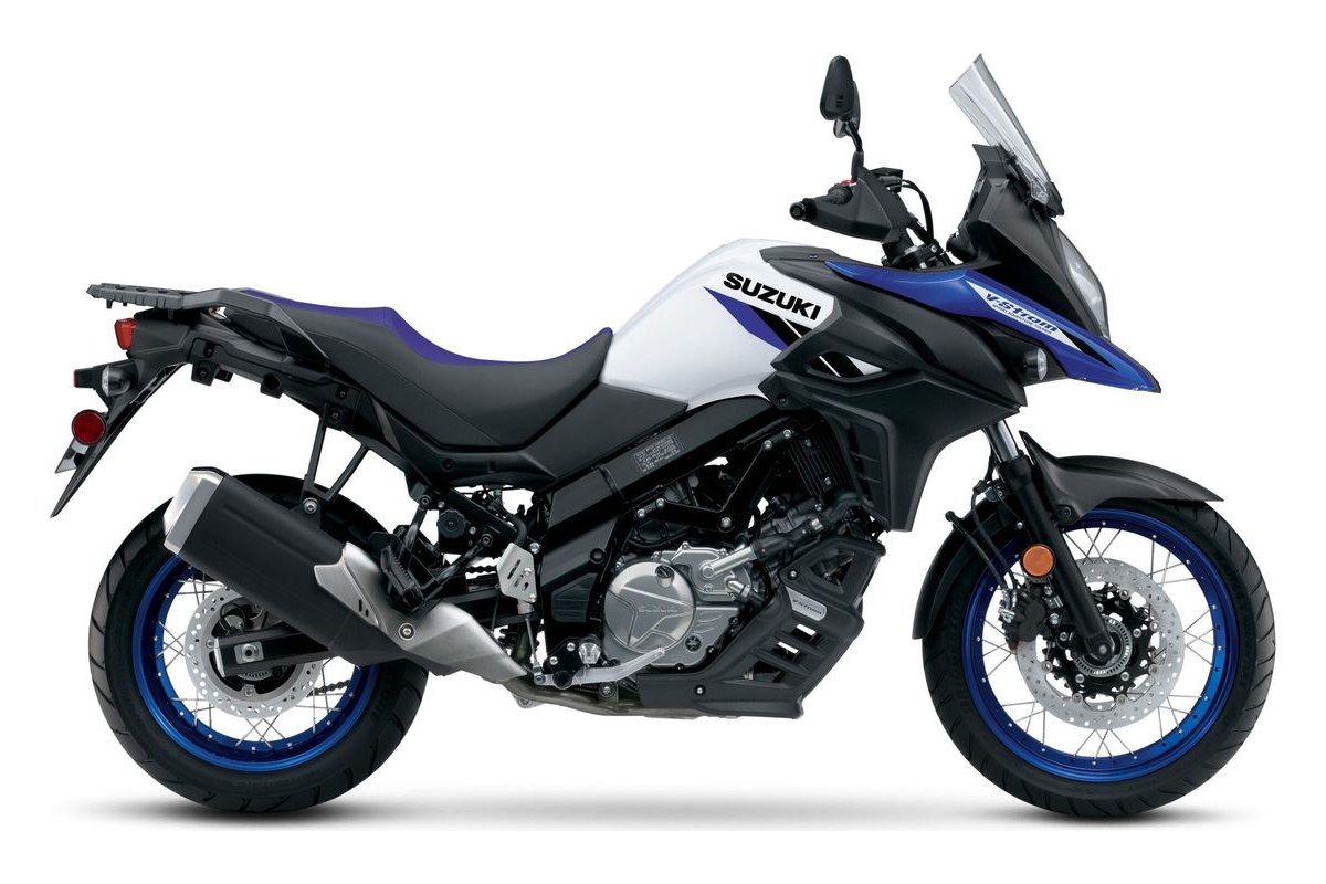 2025 Suzuki V-Strom 650XT adventure motorcycle in white and blue, right-side studio profile showing spoked wheels with blue rims and tall windscreen