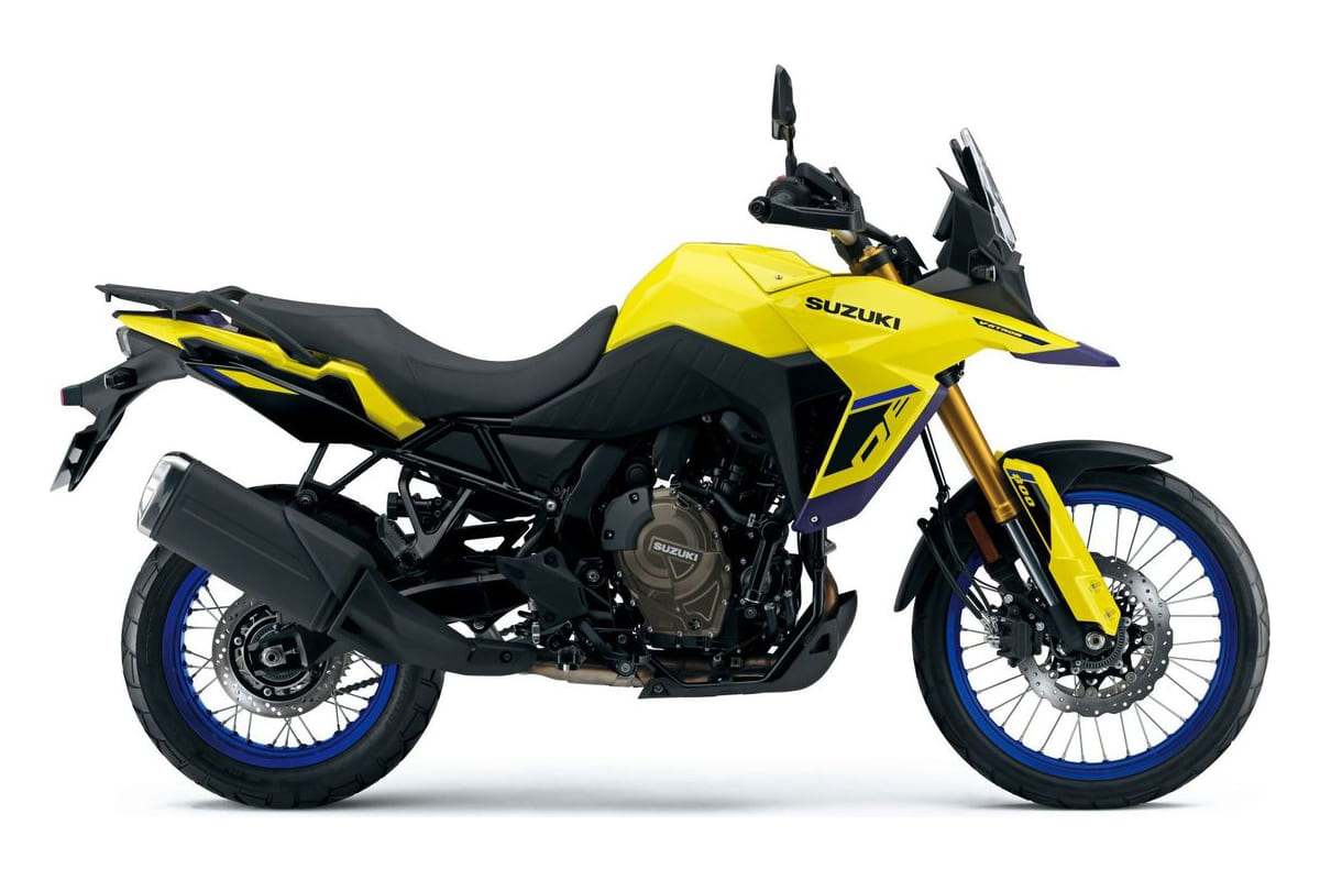 2026 Suzuki V-Strom 800DE adventure motorcycle in yellow and blue, left-side studio profile showing spoked wheels and gold-finish upside-down forks