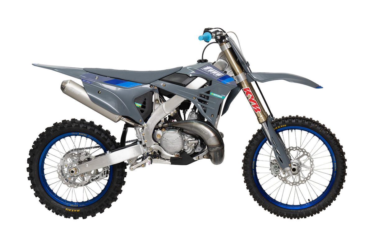 2026 TM MX 250 FI 2T motocross bike in gunmetal grey with blue accents, right-side studio profile showing the KYB forks and blue Excel rims