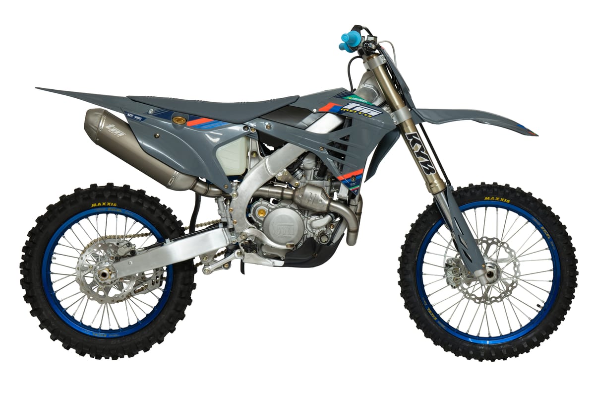 2026 TM MX 450Fi 4T motocross bike in grey with blue accents, right-side studio profile showing the KYB fork, blue Excel rims and titanium exhaust