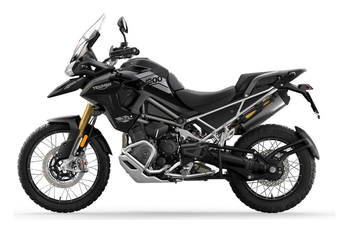 2026 Triumph Tiger 1200 Rally Pro in matte black with neon yellow graphics, left-side studio profile showing spoked wheels, tall windscreen and upswept exhaust