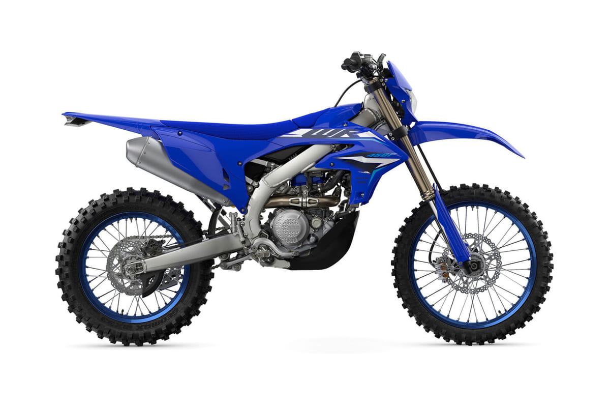 2026 Yamaha WR450F enduro bike in blue and white, right-side studio profile showing spoked wheels, front disc brake and side number plate graphics