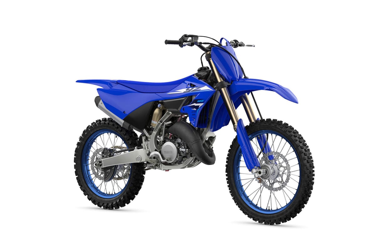 Yamaha YZ125 in Team Blue, right-side three-quarter studio view highlighting the two-stroke expansion chamber and black seat