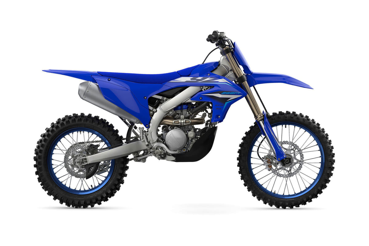 2027 Yamaha YZ250FX cross-country motorcycle in blue and white, right-side studio profile showing the titanium exhaust and spoked wheels